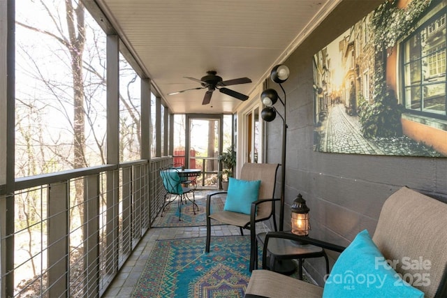 sunroom with a ceiling fan