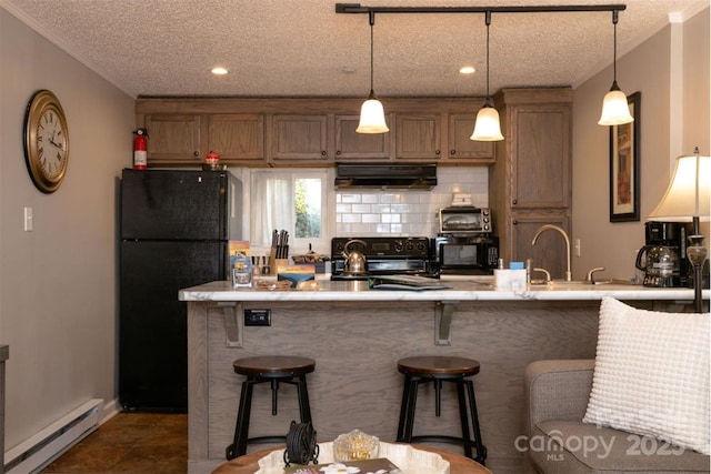 kitchen featuring ornamental molding, a kitchen breakfast bar, baseboard heating, range hood, and black appliances