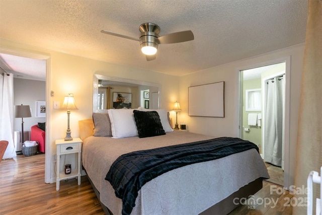 bedroom with a textured ceiling, ceiling fan, and wood finished floors
