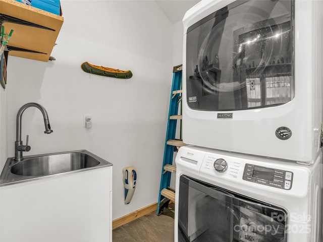 120 Ashley Ct, Mill Spring, NC 28756 - laundry room with baseboards, stacked washing maching and dryer, laundry area, and a sink