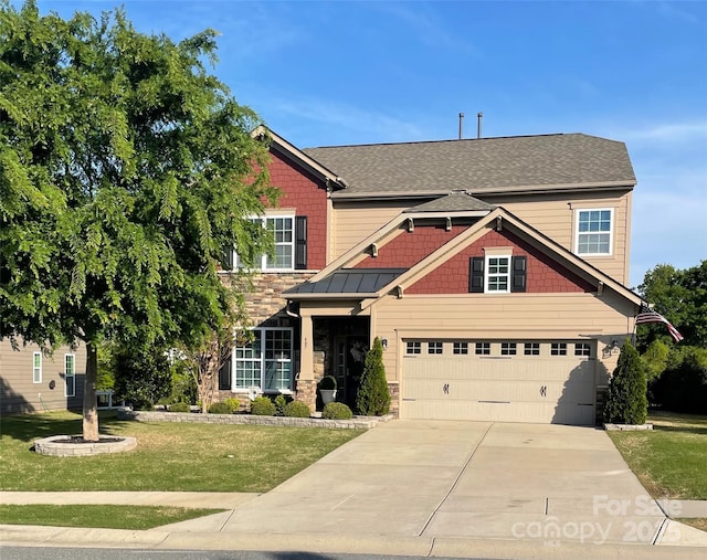 view of front facade featuring a front lawn, stone siding, a shingled roof, an attached garage, and driveway