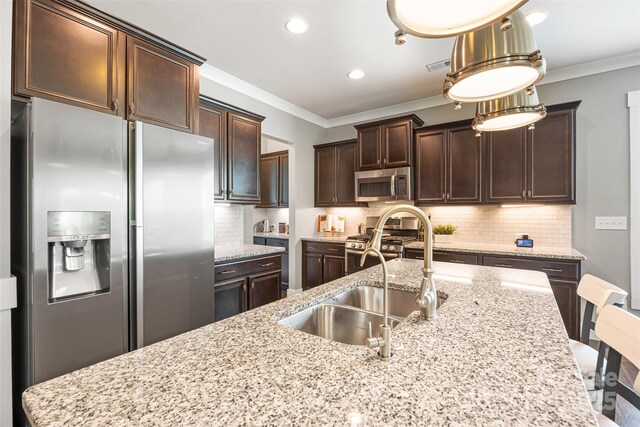 kitchen featuring a sink, crown molding, stainless steel appliances, and dark brown cabinets