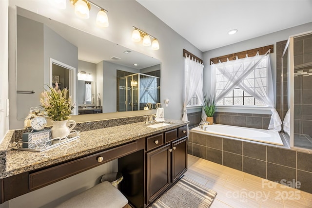 bathroom featuring vanity, tile patterned flooring, a shower stall, and a bath