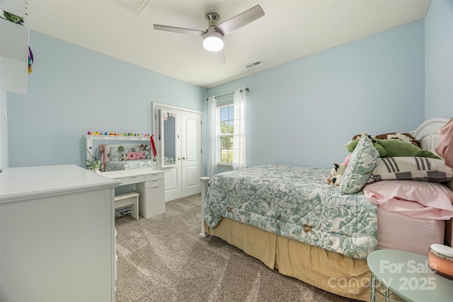 bedroom featuring a ceiling fan, light colored carpet, visible vents, and a closet