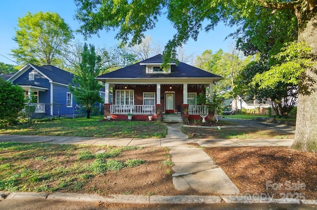 247 W Park Ave, Charlotte, NC 28203 - bungalow-style home featuring brick siding, a front yard, and covered porch