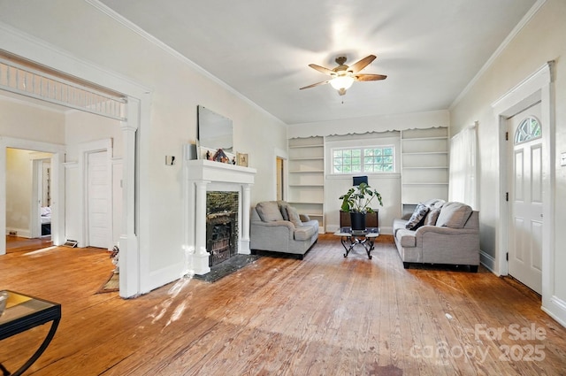 247 W Park Ave, Charlotte, NC 28203 - living area with built in features, ornamental molding, a ceiling fan, a fireplace, and hardwood / wood-style floors