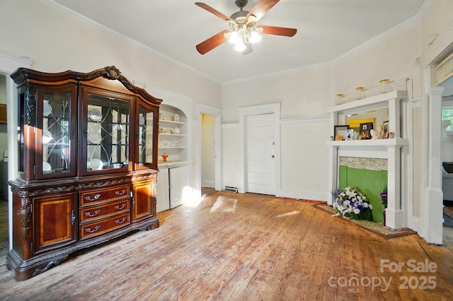 247 W Park Ave, Charlotte, NC 28203 - interior space with built in features, a fireplace, ornamental molding, a ceiling fan, and wood finished floors