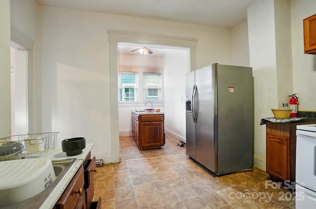 247 W Park Ave, Charlotte, NC 28203 - kitchen featuring stainless steel fridge with ice dispenser, brown cabinetry, white electric range oven, and baseboards
