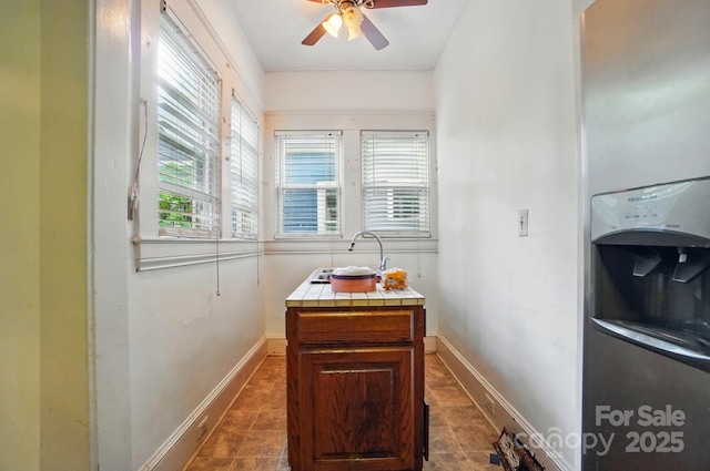 247 W Park Ave, Charlotte, NC 28203 - kitchen with tile countertops, baseboards, a sink, and a ceiling fan