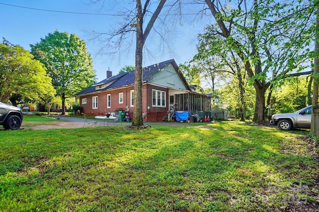 247 W Park Ave, Charlotte, NC 28203 - view of side of home featuring a chimney, a sunroom, and a lawn