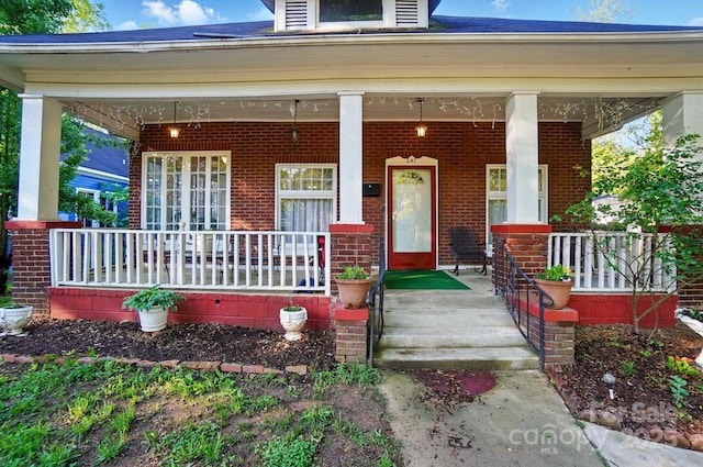 247 W Park Ave, Charlotte, NC 28203 - view of exterior entry featuring a porch and brick siding