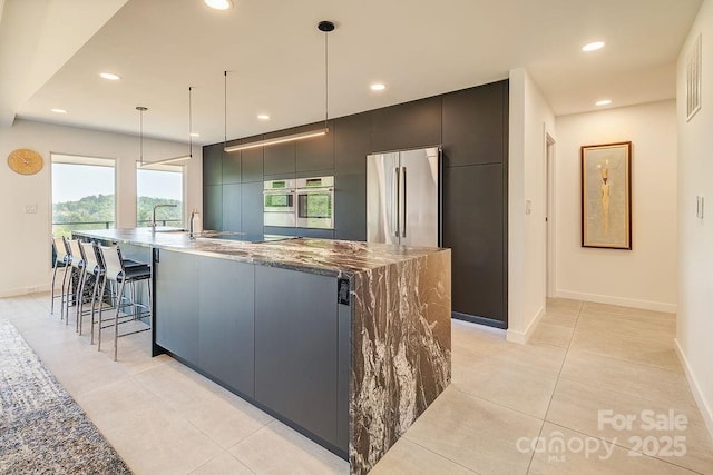 kitchen with recessed lighting, stainless steel appliances, and a spacious island