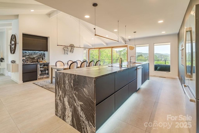 kitchen featuring dishwasher, beverage cooler, decorative backsplash, a spacious island, and modern cabinets