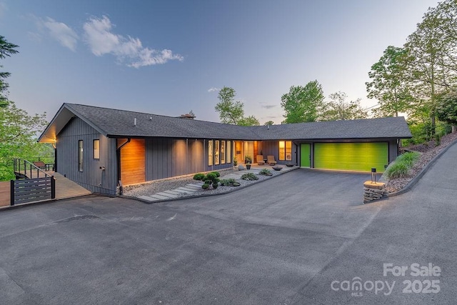 view of front facade featuring an attached garage and aphalt driveway