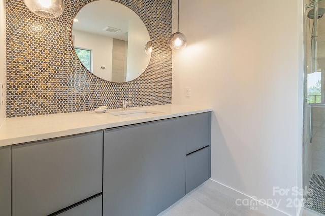 full bath with vanity, tile patterned floors, visible vents, and tasteful backsplash