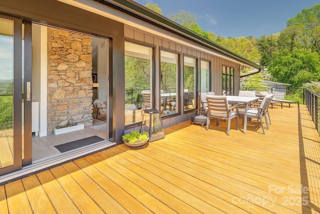 wooden deck featuring outdoor dining area