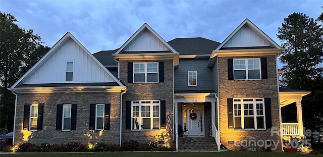 view of front facade with brick siding and board and batten siding