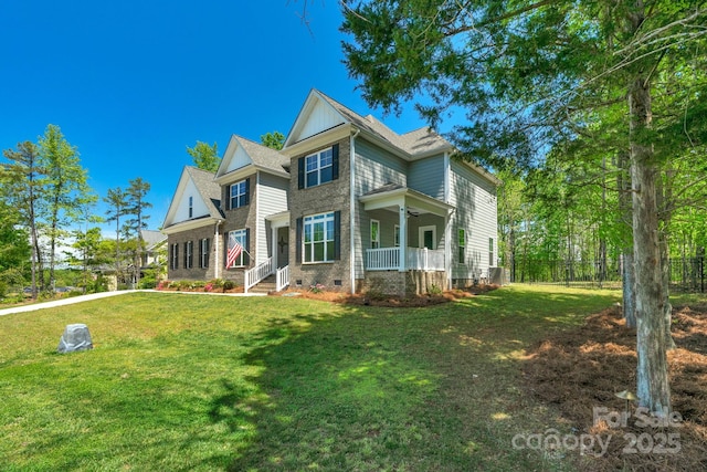 rear view of house featuring a lawn, fence, a porch, and crawl space