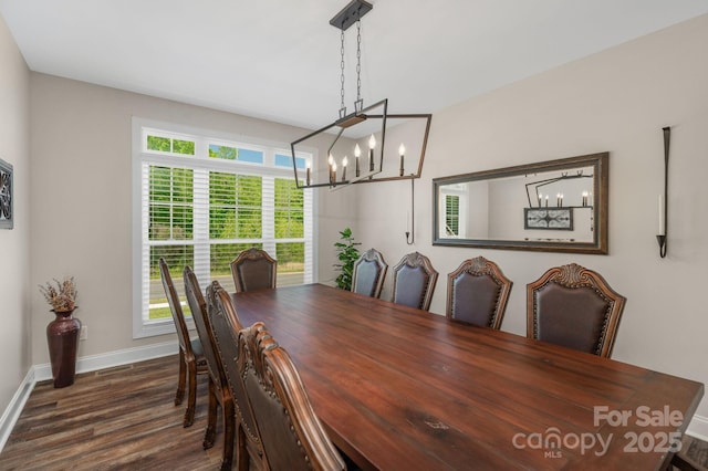 dining room featuring baseboards, a chandelier, and dark wood finished floors