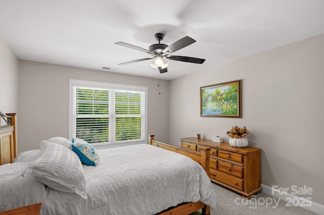 carpeted bedroom with ceiling fan, visible vents, and baseboards