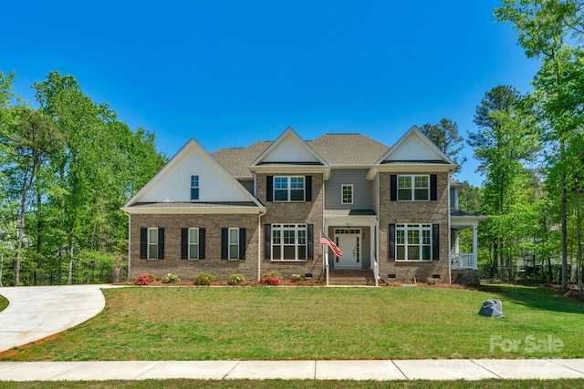 view of front of property with a front yard, brick siding, and crawl space