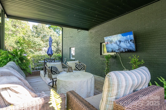 view of patio / terrace featuring outdoor dining area and a wooden deck