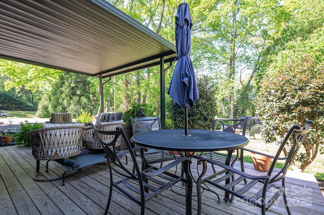 wooden terrace with outdoor dining area