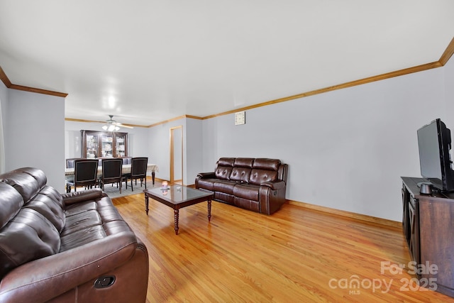 living room with light wood-style floors, ceiling fan, and ornamental molding