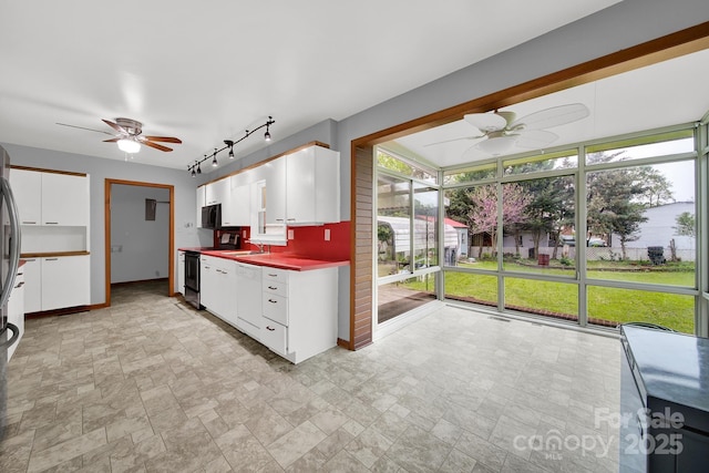 kitchen featuring track lighting, electric range, a ceiling fan, and black microwave