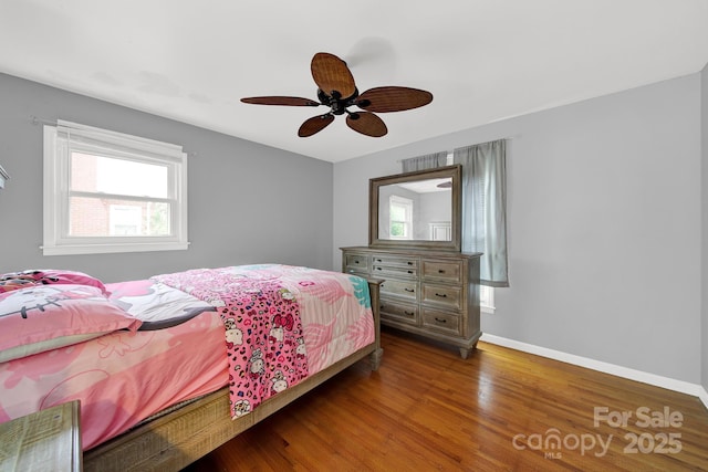 bedroom featuring baseboards, a ceiling fan, and wood finished floors