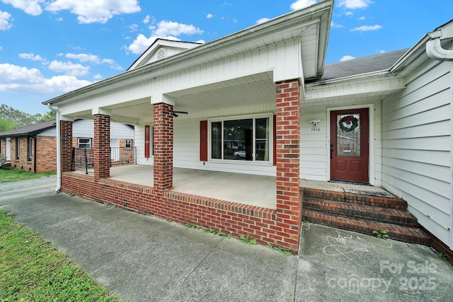 view of front of property featuring brick siding and a porch