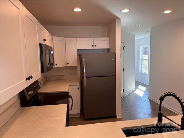 190 Honeycutt Dr, Connelly Springs, NC 28612 - kitchen featuring white cabinets, baseboards, light countertops, recessed lighting, and black appliances