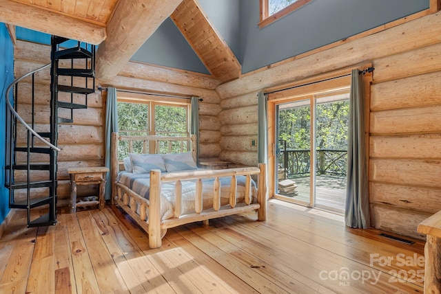bedroom featuring rustic walls, access to outside, visible vents, light wood-style flooring, and multiple windows