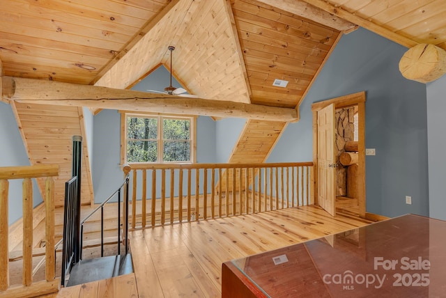 additional living space featuring hardwood / wood-style floors, wooden ceiling, vaulted ceiling with beams, and ceiling fan