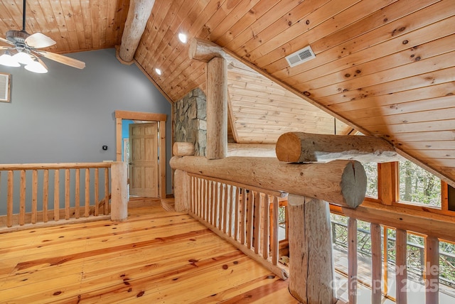 hallway with wooden ceiling, hardwood / wood-style floors, beamed ceiling, an upstairs landing, and high vaulted ceiling