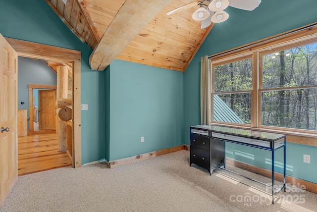 interior space with carpet flooring, ceiling fan, vaulted ceiling, and wood ceiling
