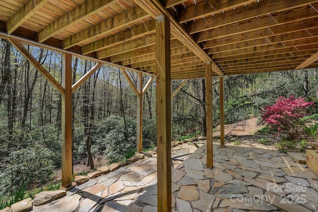 view of patio featuring a forest view