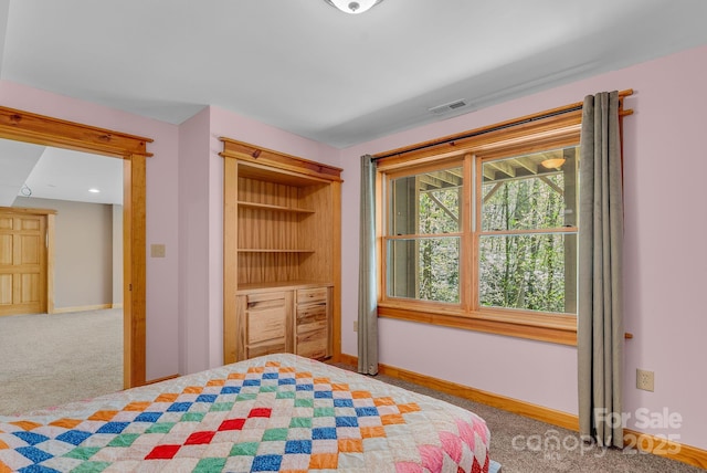 carpeted bedroom with visible vents and baseboards