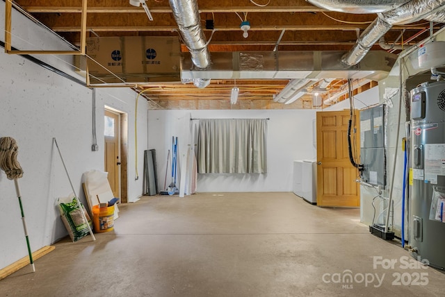 unfinished basement with washer / clothes dryer and water heater