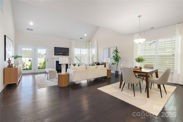 1005 Argentium Way, Waxhaw, NC 28173 - dining room featuring high vaulted ceiling, dark wood-style floors, a glass covered fireplace, and recessed lighting