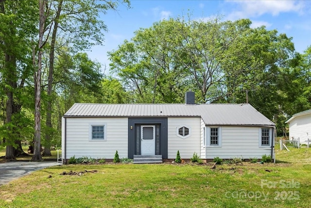 165 N Mitchell St, Rutherfordton, NC 28139 - ranch-style house featuring a chimney, metal roof, and a front lawn