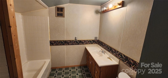 bathroom with lofted ceiling, vanity, and visible vents