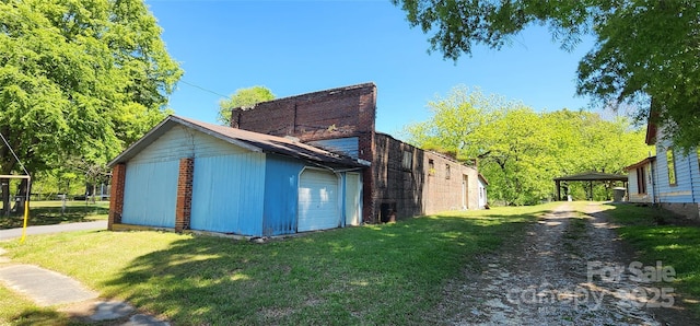 view of property exterior featuring a detached carport and a lawn