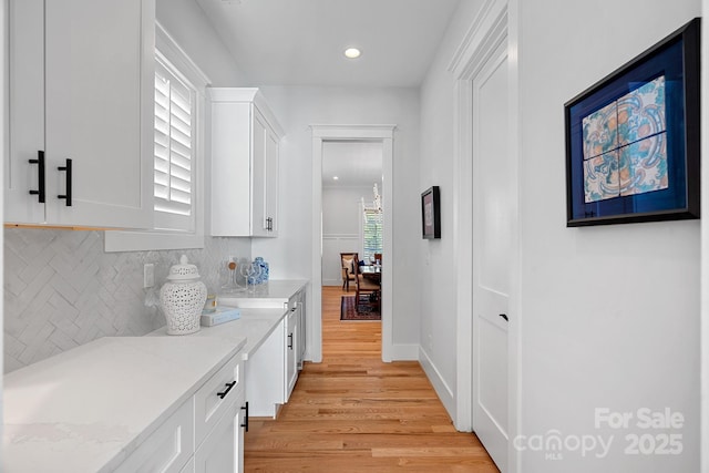 interior space featuring light wood-style floors, baseboards, and recessed lighting