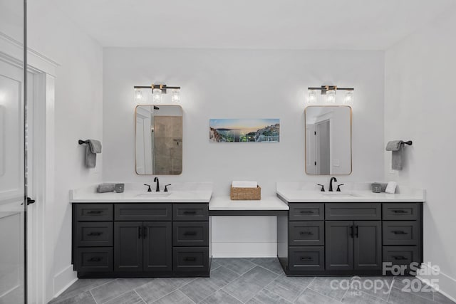 bathroom featuring baseboards, tiled shower, tile patterned floors, and vanity