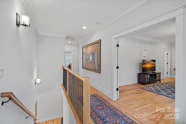 corridor featuring wood finished floors, an upstairs landing, crown molding, baseboards, and recessed lighting