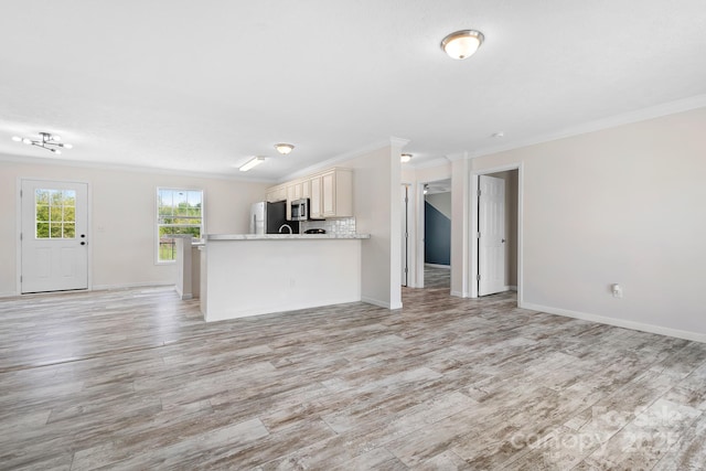 123 Pumice Dr, Statesville, NC 28625 - kitchen featuring open floor plan, crown molding, stainless steel appliances, light wood-style floors, and light countertops