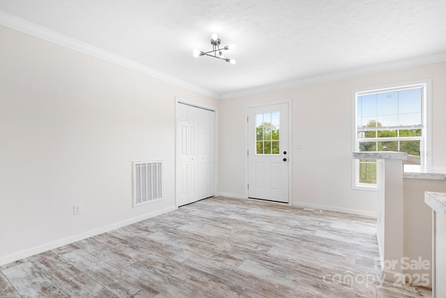 123 Pumice Dr, Statesville, NC 28625 - entryway with crown molding, light wood-type flooring, baseboards, and a chandelier