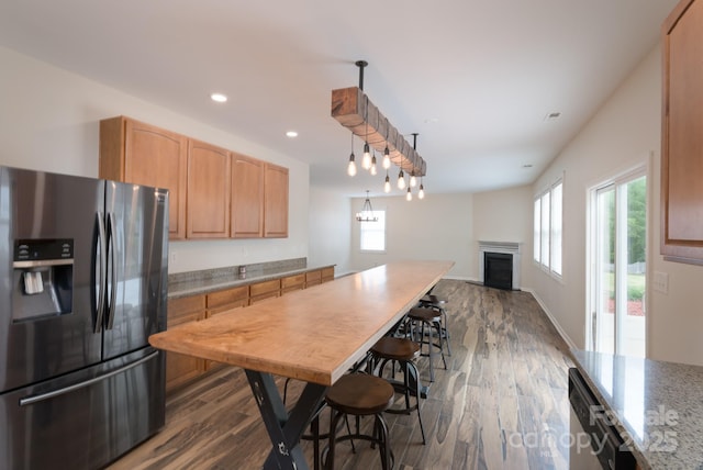 1144 Spicewood Pines Rd, Fort Mill, SC 29708 - kitchen featuring appliances with stainless steel finishes, healthy amount of natural light, a fireplace, dark wood-type flooring, and recessed lighting