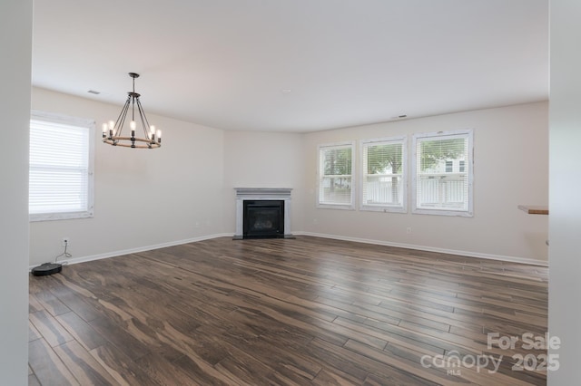 1144 Spicewood Pines Rd, Fort Mill, SC 29708 - unfurnished living room with a chandelier, dark wood finished floors, a glass covered fireplace, and baseboards